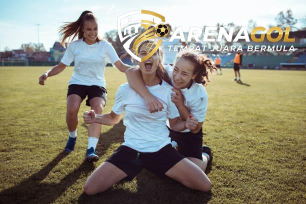 Close up of a female soccer team celebrating a scored goal